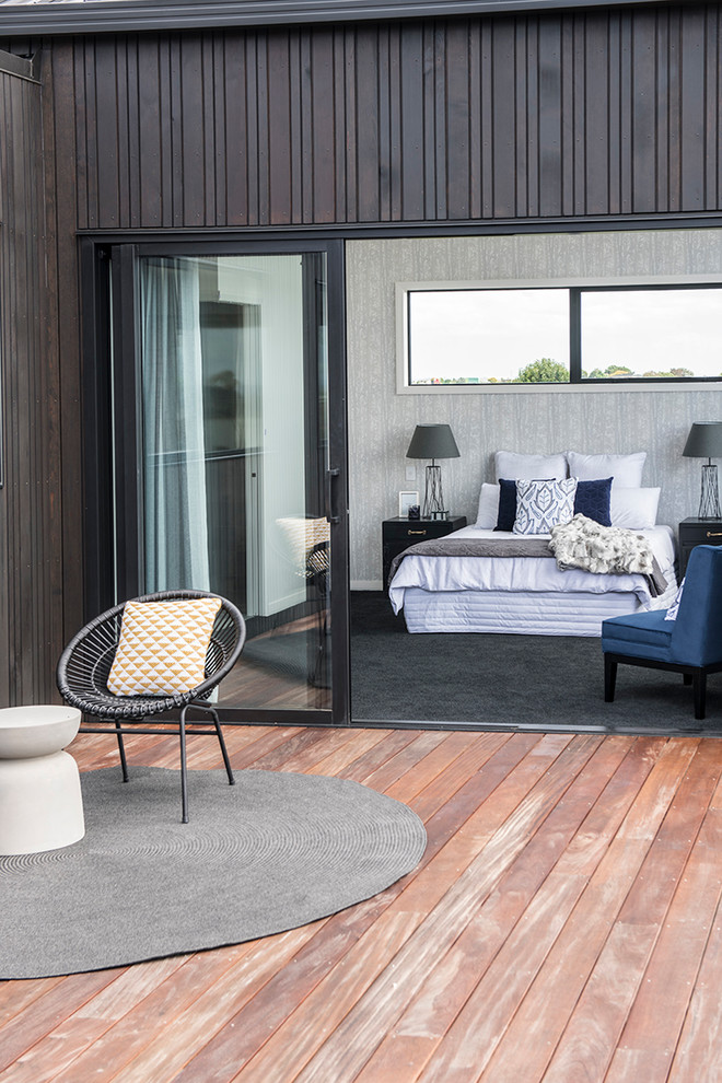 This is an example of a mid-sized contemporary backyard deck in Auckland with no cover.