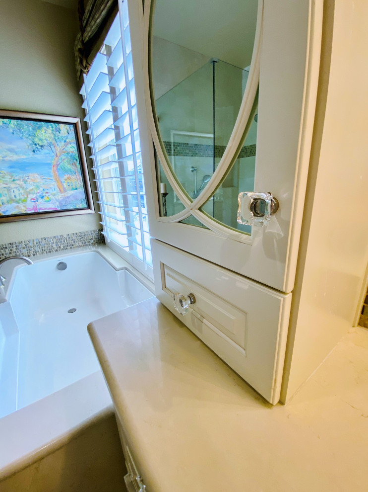 This is an example of a large traditional master bathroom in San Francisco with raised-panel cabinets, beige cabinets, an undermount tub, a corner shower, a one-piece toilet, beige tile, porcelain tile, beige walls, porcelain floors, an undermount sink, marble benchtops, beige floor, a sliding shower screen, beige benchtops, an enclosed toilet, a double vanity and a built-in vanity.