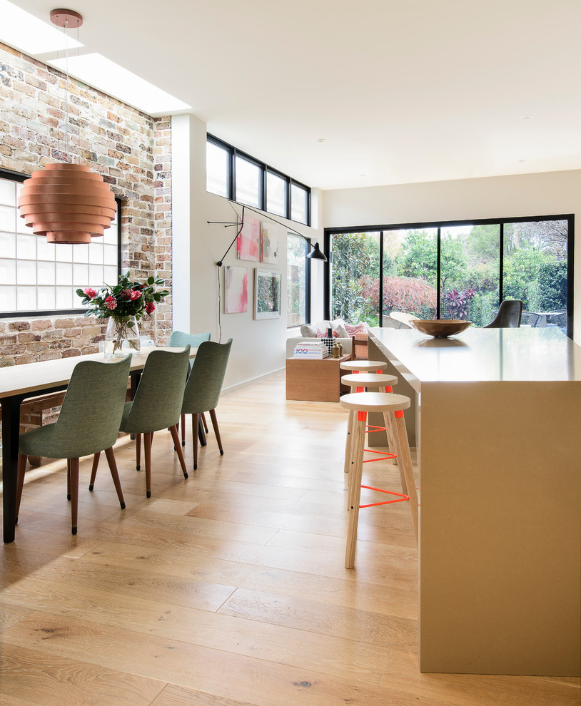 Inspiration for a kitchen in Sydney with quartz benchtops, beige splashback and light hardwood floors.