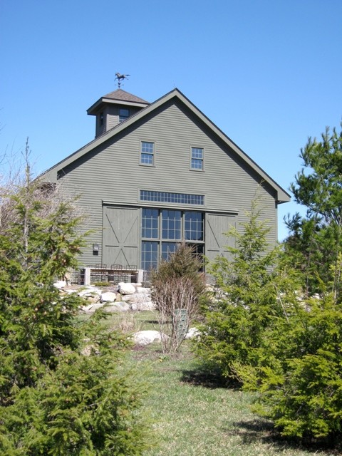 Inspiration for a rustic green two-story wood gable roof remodel with a shingle roof