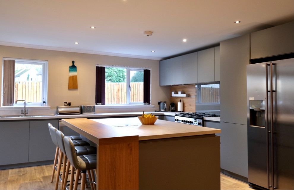Design ideas for a mid-sized modern open plan kitchen in Other with grey splashback, with island and white benchtop.