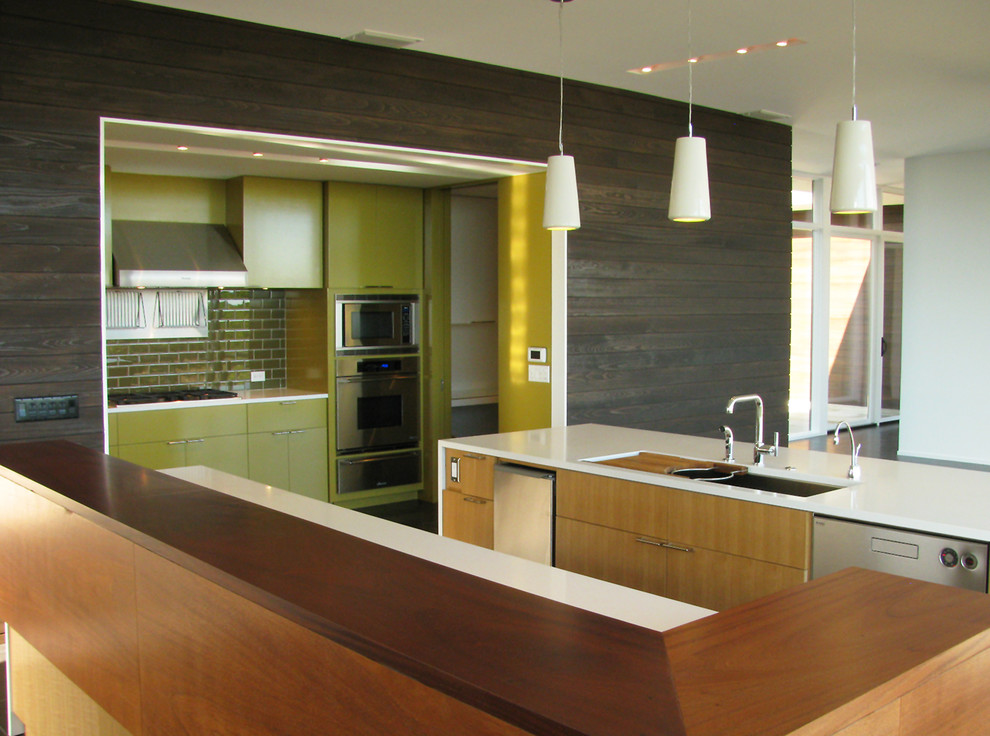 Inspiration for a mid-sized modern l-shaped open plan kitchen in Austin with a double-bowl sink, light wood cabinets, green splashback, ceramic splashback, stainless steel appliances, flat-panel cabinets, quartz benchtops, multiple islands, ceramic floors and black floor.
