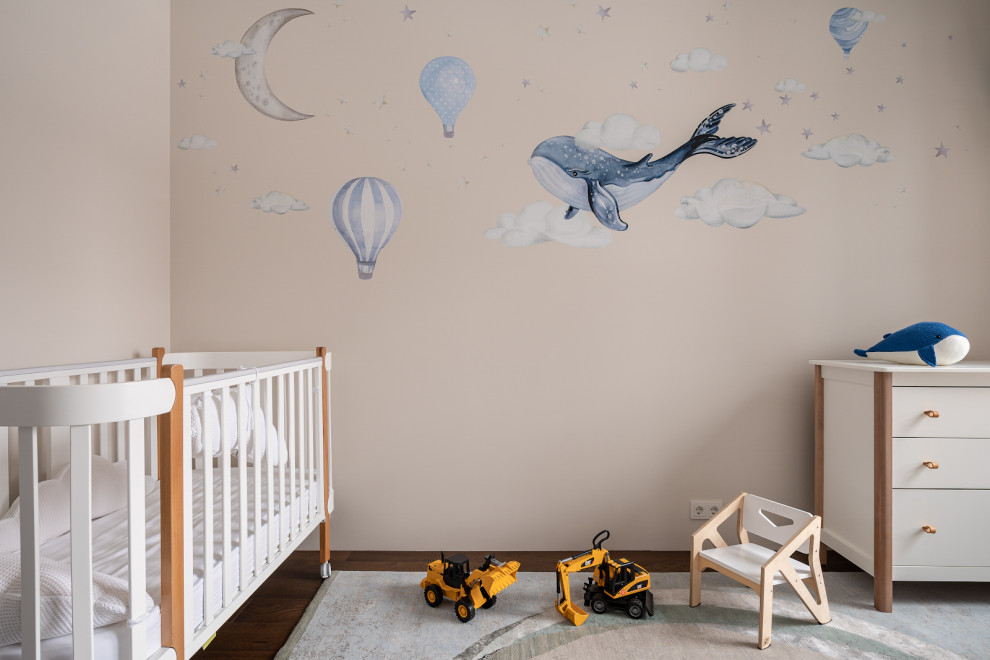 This is an example of a medium sized contemporary toddler’s room for boys in Moscow with beige walls, medium hardwood flooring and wallpapered walls.
