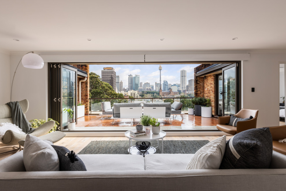 Inspiration for a contemporary living room in Sydney with white walls and light hardwood floors.