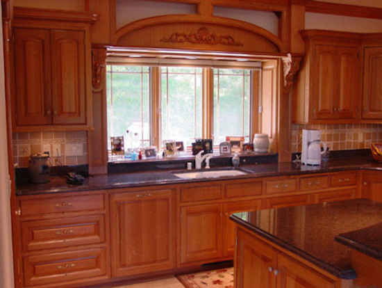 Arts and crafts u-shaped eat-in kitchen in Milwaukee with raised-panel cabinets, medium wood cabinets, granite benchtops, ceramic floors and with island.