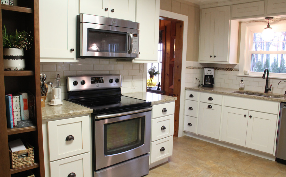 Small transitional l-shaped eat-in kitchen photo with an undermount sink, shaker cabinets, white cabinets, quartz countertops, white backsplash, subway tile backsplash, stainless steel appliances and no island