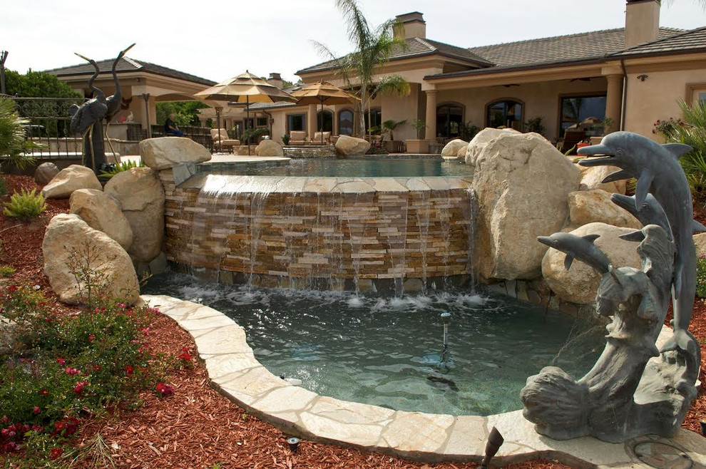 Mid-sized transitional backyard concrete paver and custom-shaped lap hot tub photo in Los Angeles