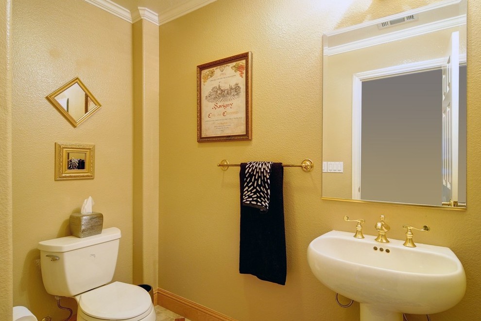 Photo of a small traditional powder room in San Francisco with yellow walls.