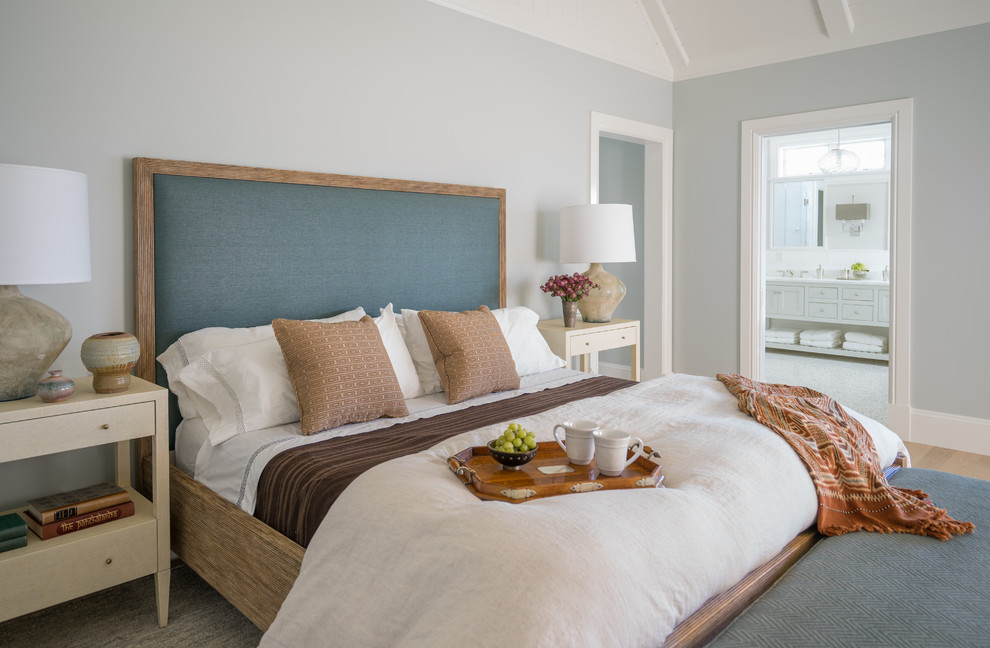 Photo of a beach style master bedroom in Boston with grey walls and beige floor.