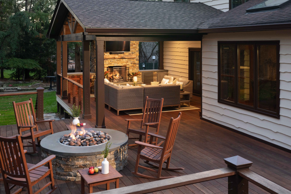 Deck - huge traditional backyard cable railing deck idea in Other with a fireplace and a roof extension