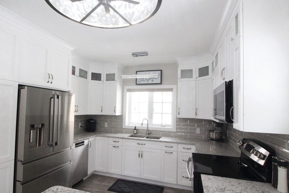 Inspiration for an u-shaped kitchen remodel with shaker cabinets, white cabinets, quartzite countertops, gray backsplash, subway tile backsplash, a peninsula and gray countertops