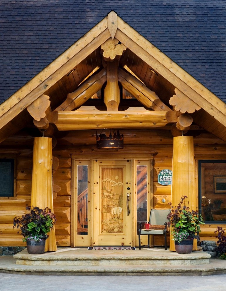 This is an example of a country entryway in Boise with a single front door and a light wood front door.