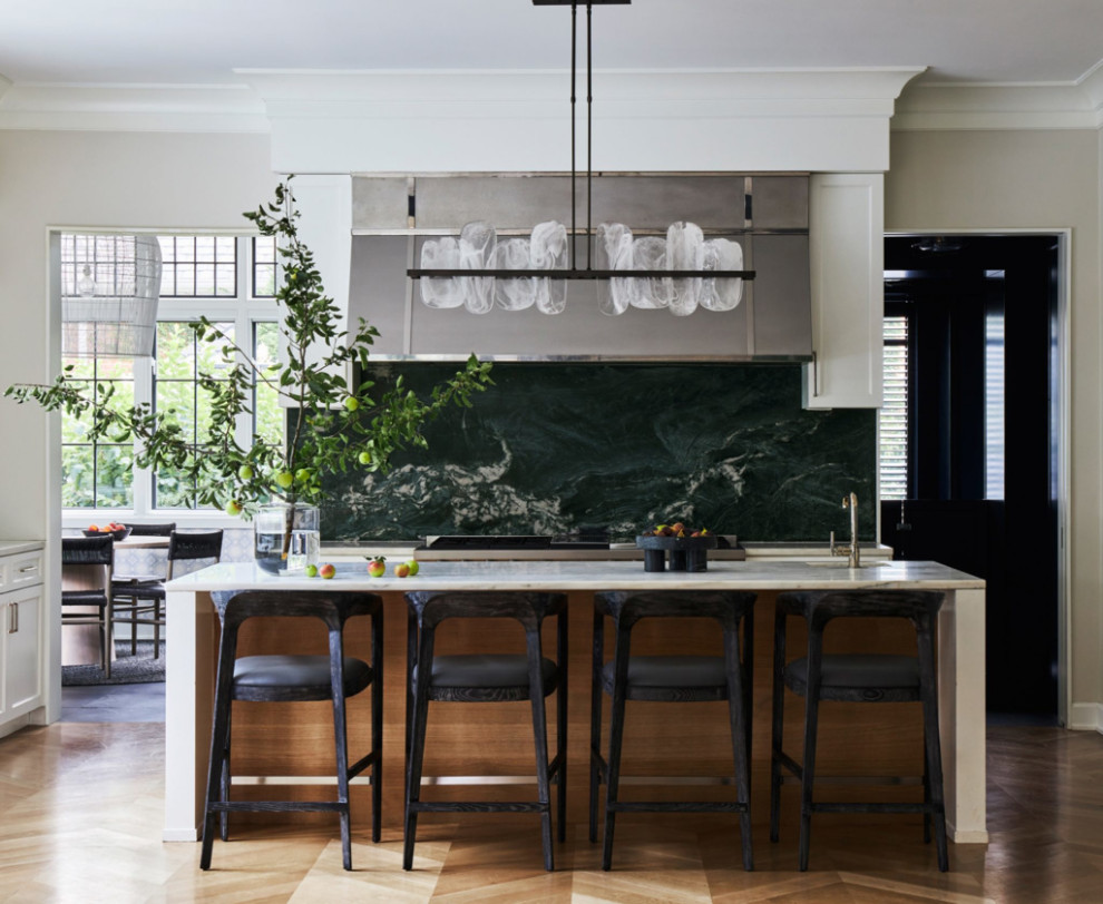 Example of a mid-sized trendy l-shaped light wood floor, brown floor and vaulted ceiling open concept kitchen design in New York with a single-bowl sink, shaker cabinets, white cabinets, quartz countertops, green backsplash, quartz backsplash, stainless steel appliances, an island and white countertops