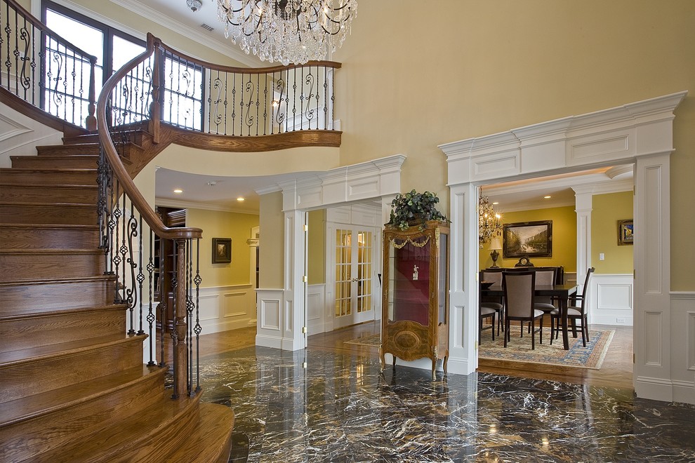 This is an example of a traditional wood curved staircase in Boston with wood risers and mixed railing.