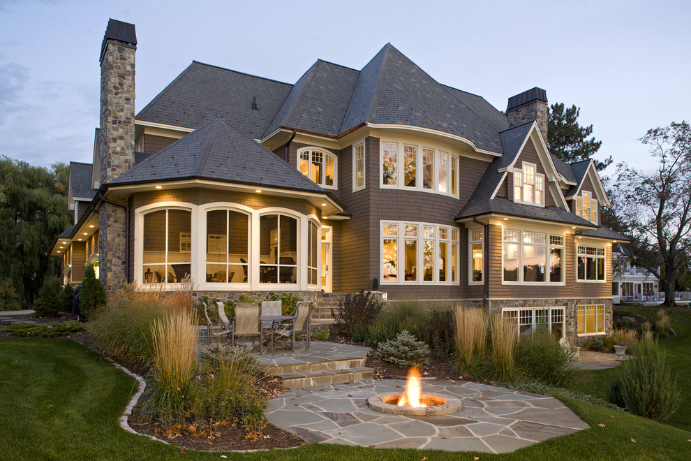 Design ideas for a large traditional three-storey exterior in Minneapolis with wood siding.