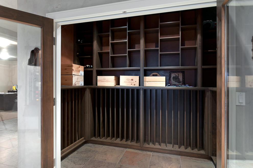 Photo of a mid-sized contemporary wine cellar in Vancouver with slate floors and display racks.