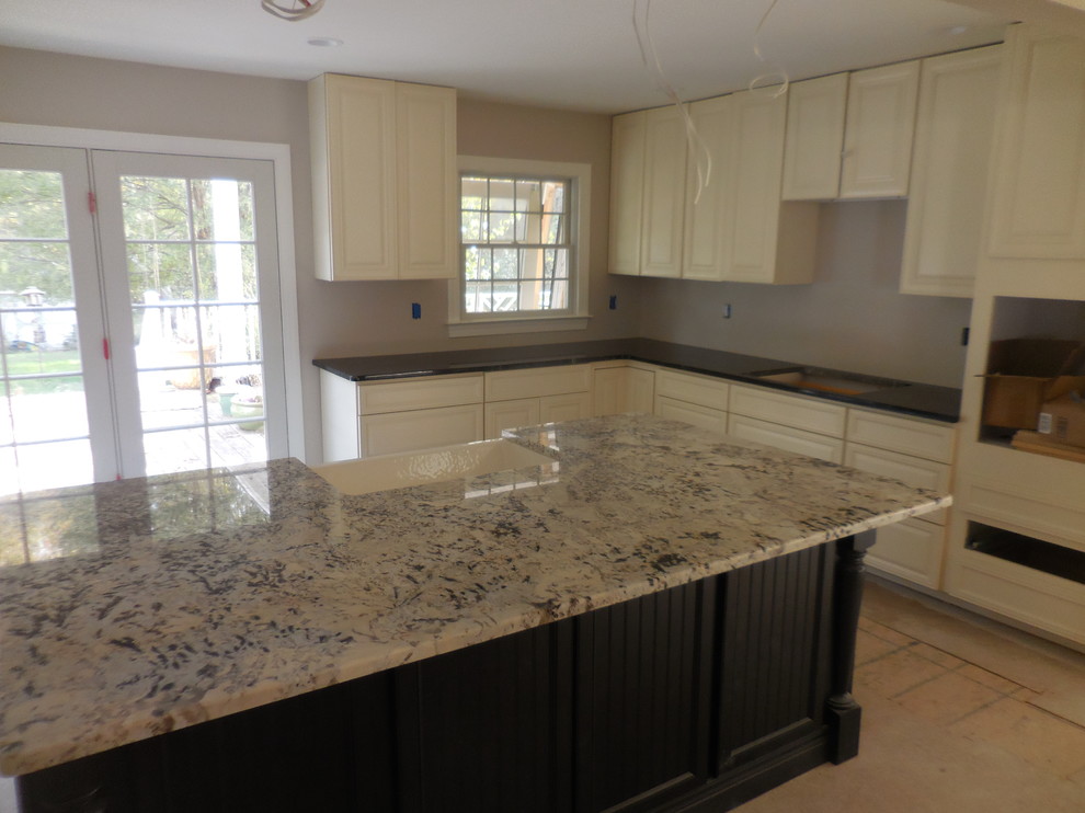 Mid-sized transitional l-shaped eat-in kitchen photo in Baltimore with a farmhouse sink, raised-panel cabinets, white cabinets, granite countertops and an island