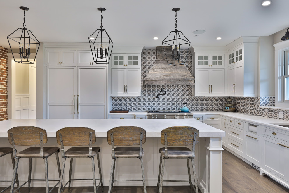 Example of a huge country u-shaped dark wood floor and brown floor eat-in kitchen design in Philadelphia with beaded inset cabinets, white cabinets, an island, an undermount sink, quartzite countertops, white backsplash, ceramic backsplash, paneled appliances and white countertops