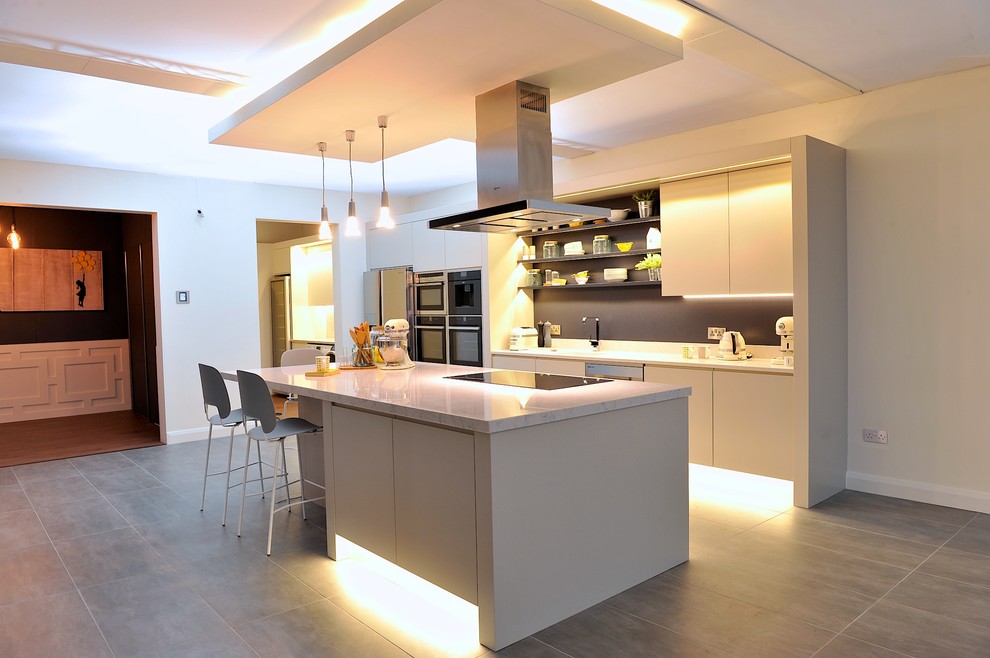 Inspiration for a mid-sized modern single-wall open plan kitchen in Dublin with a drop-in sink, flat-panel cabinets, grey cabinets, quartzite benchtops, multi-coloured splashback, porcelain floors and with island.