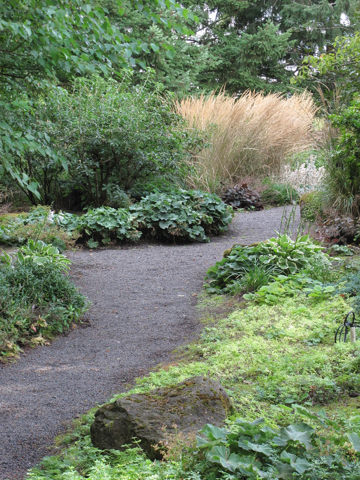 This is an example of a large traditional backyard partial sun formal garden in Portland with a garden path and gravel.