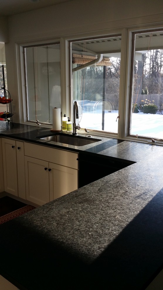 Mid-sized transitional u-shaped dark wood floor eat-in kitchen photo with a single-bowl sink, recessed-panel cabinets, white cabinets, granite countertops, white backsplash, ceramic backsplash and stainless steel appliances