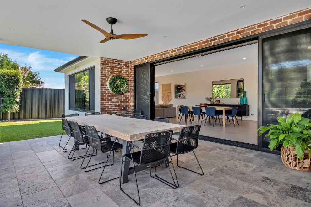 Design ideas for a mid-sized contemporary backyard patio in Sydney.
