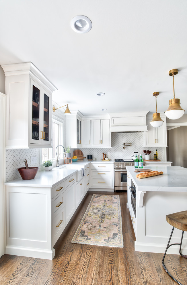 This is an example of a transitional kitchen in New York with a farmhouse sink, white cabinets, quartz benchtops, panelled appliances and dark hardwood floors.