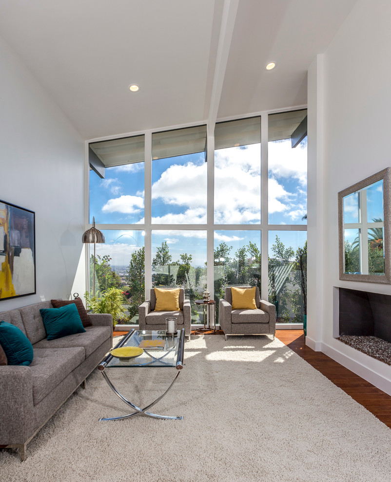 Mid-sized 1960s open concept dark wood floor living room photo in Los Angeles with a standard fireplace