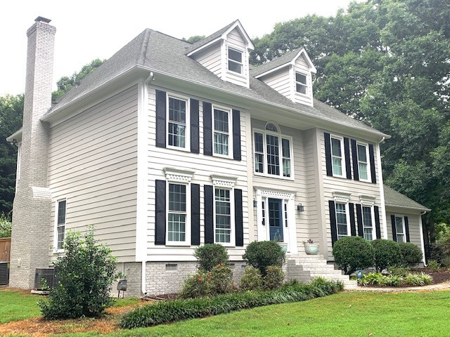Large modern gray two-story wood exterior home idea in Charlotte