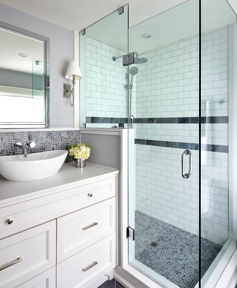 Inspiration for a small transitional master bathroom in Toronto with recessed-panel cabinets, white cabinets, a corner shower, gray tile, grey walls, a vessel sink, engineered quartz benchtops, mosaic tile and mosaic tile floors.
