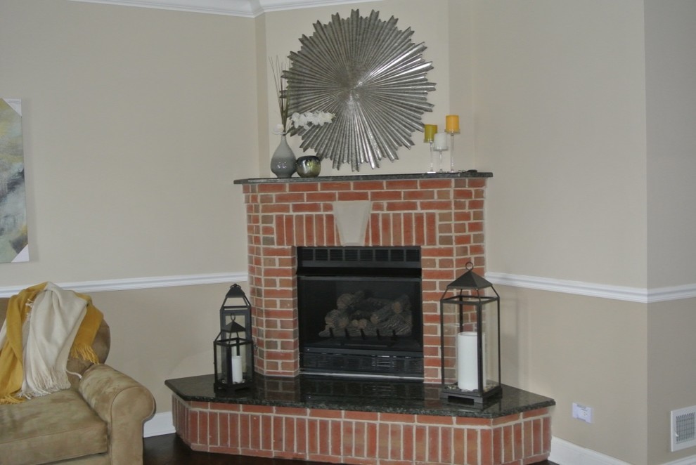 Transitional living room photo in Chicago with a corner fireplace and a brick fireplace