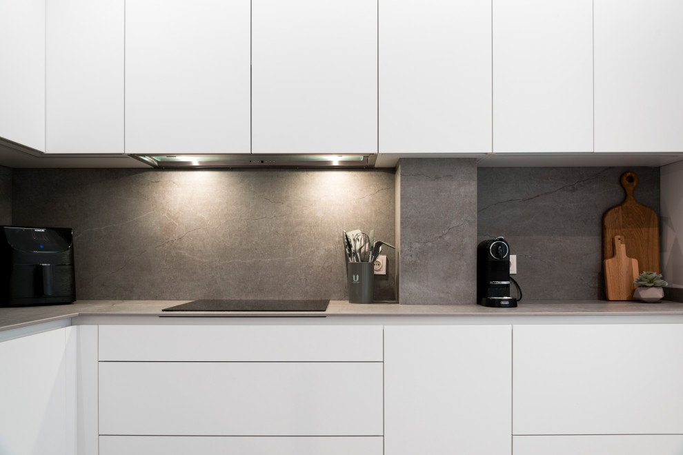 Inspiration for a small contemporary grey and white l-shaped enclosed kitchen in Other with a submerged sink, flat-panel cabinets, white cabinets, grey splashback, stainless steel appliances, ceramic flooring, no island, grey floors and grey worktops.