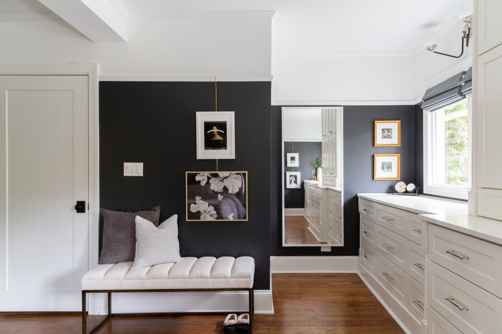 Inspiration for a transitional medium tone wood floor and brown floor bedroom remodel in Chicago with black walls