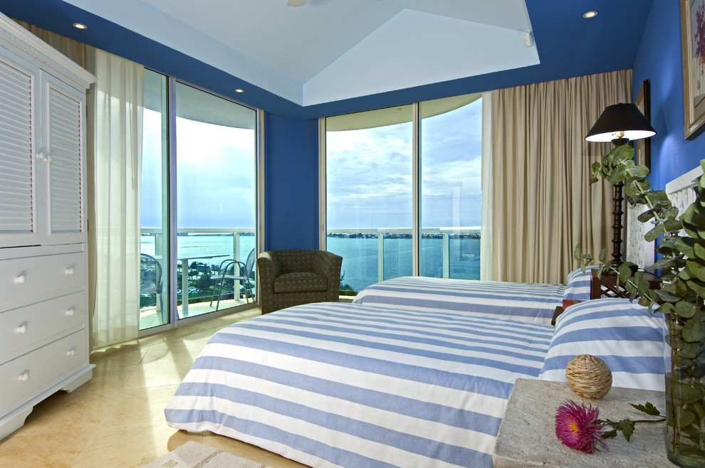 Photo of a tropical bedroom in Other with blue walls.