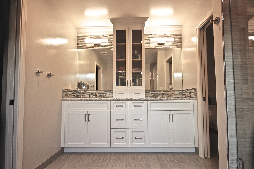 This is an example of a large transitional master bathroom in San Francisco with an undermount sink, shaker cabinets, white cabinets, engineered quartz benchtops, a freestanding tub, a corner shower, a two-piece toilet, gray tile, porcelain tile, grey walls and porcelain floors.