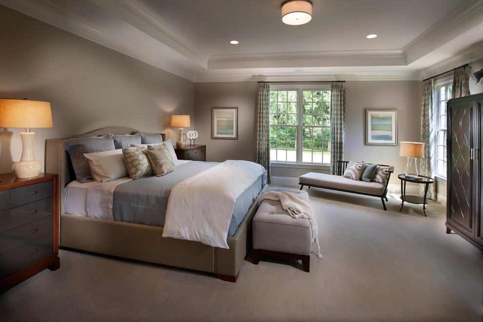 This is an example of a large traditional master bedroom in Charlotte with beige walls and carpet.