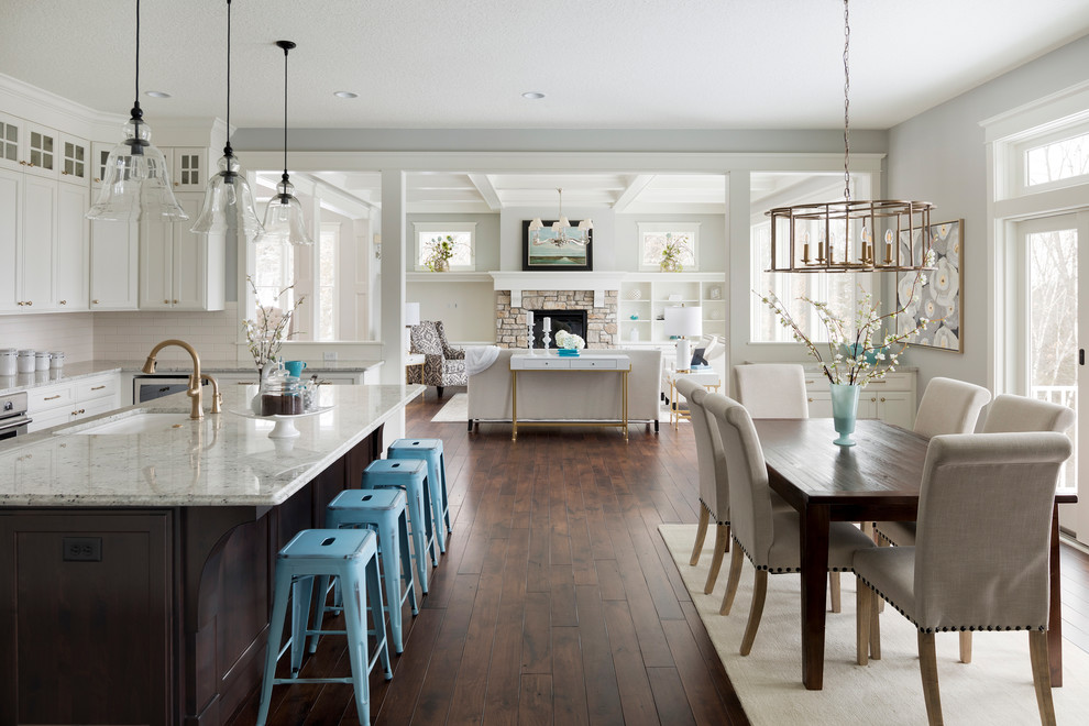 Inspiration for a large traditional u-shaped eat-in kitchen in Other with an undermount sink, recessed-panel cabinets, white cabinets, granite benchtops, dark hardwood floors, with island and brown floor.