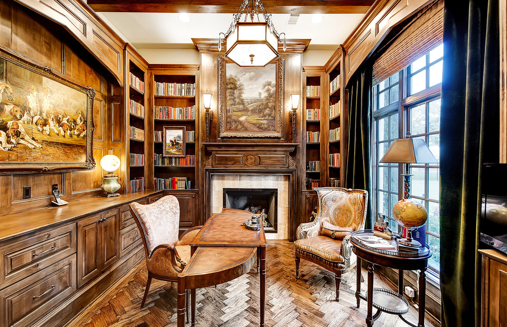 Photo of a mid-sized traditional home office in Dallas with brown walls, dark hardwood floors, a standard fireplace, a freestanding desk, a library and a tile fireplace surround.