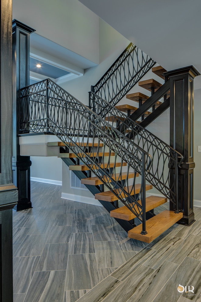 Example of a transitional concrete metal railing staircase design with wooden risers