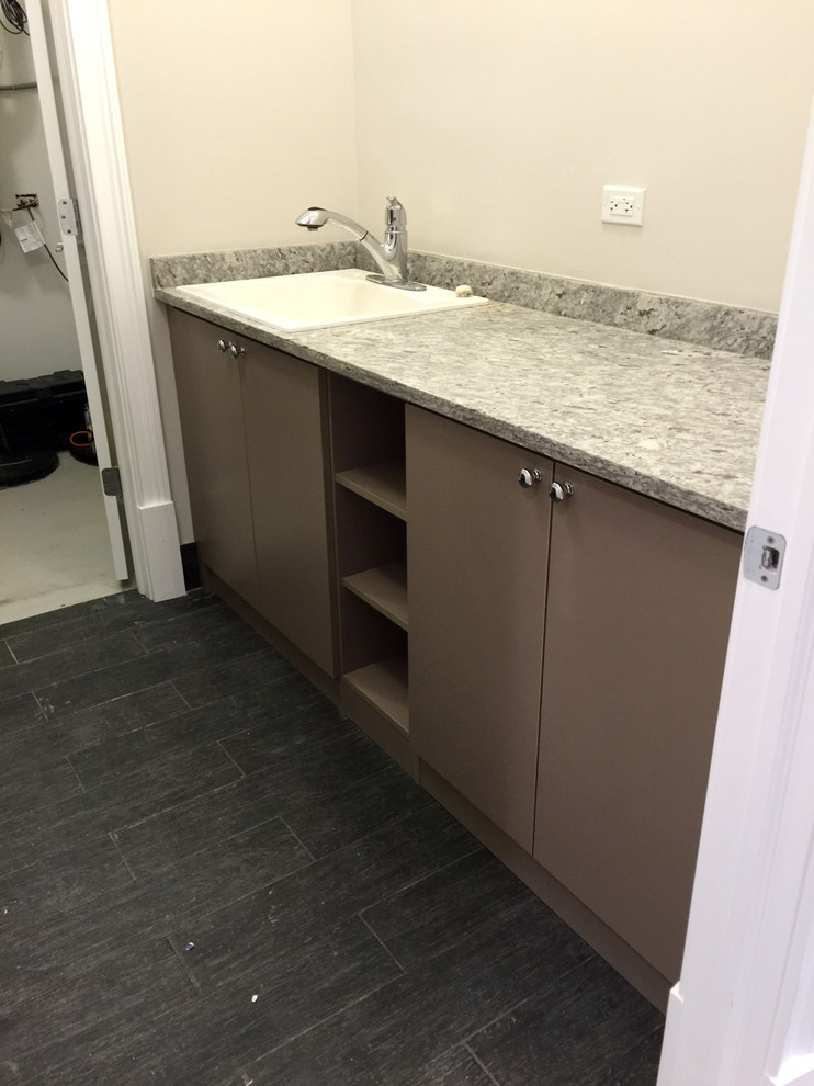 Mid-sized contemporary utility room in Chicago with flat-panel cabinets, brown cabinets and a side-by-side washer and dryer.