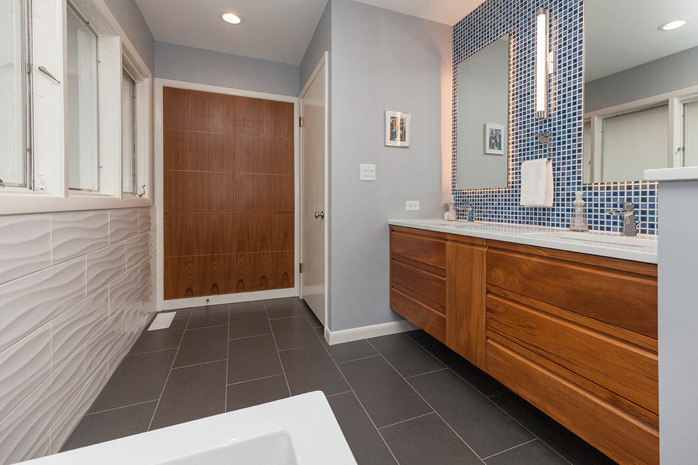 Mid-sized transitional master bathroom in Other with shaker cabinets, medium wood cabinets, a freestanding tub, an open shower, a one-piece toilet, gray tile, terra-cotta tile, blue walls, porcelain floors, a drop-in sink, quartzite benchtops, grey floor and an open shower.