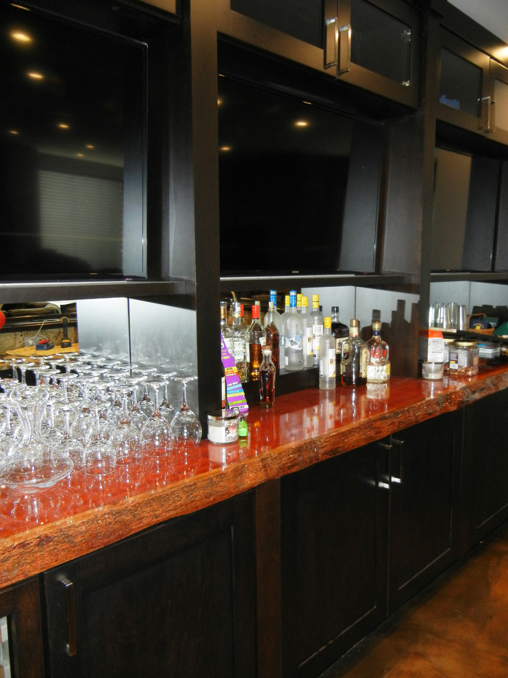 Design ideas for a contemporary home bar in Other with flat-panel cabinets, dark wood cabinets, wood benchtops, mirror splashback, concrete floors, brown floor and orange benchtop.