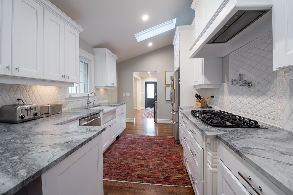 Design ideas for a mid-sized transitional galley separate kitchen in Salt Lake City with beaded inset cabinets, white cabinets, granite benchtops, white splashback, cement tile splashback, stainless steel appliances and no island.