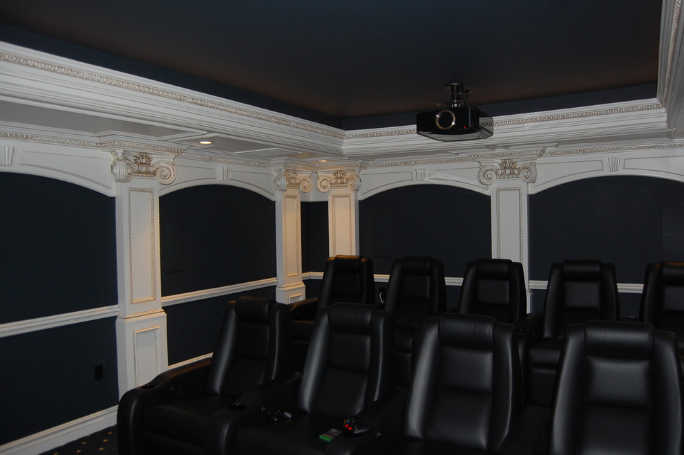 This is an example of a large traditional enclosed home theatre in New York with blue walls, carpet, a projector screen and blue floor.