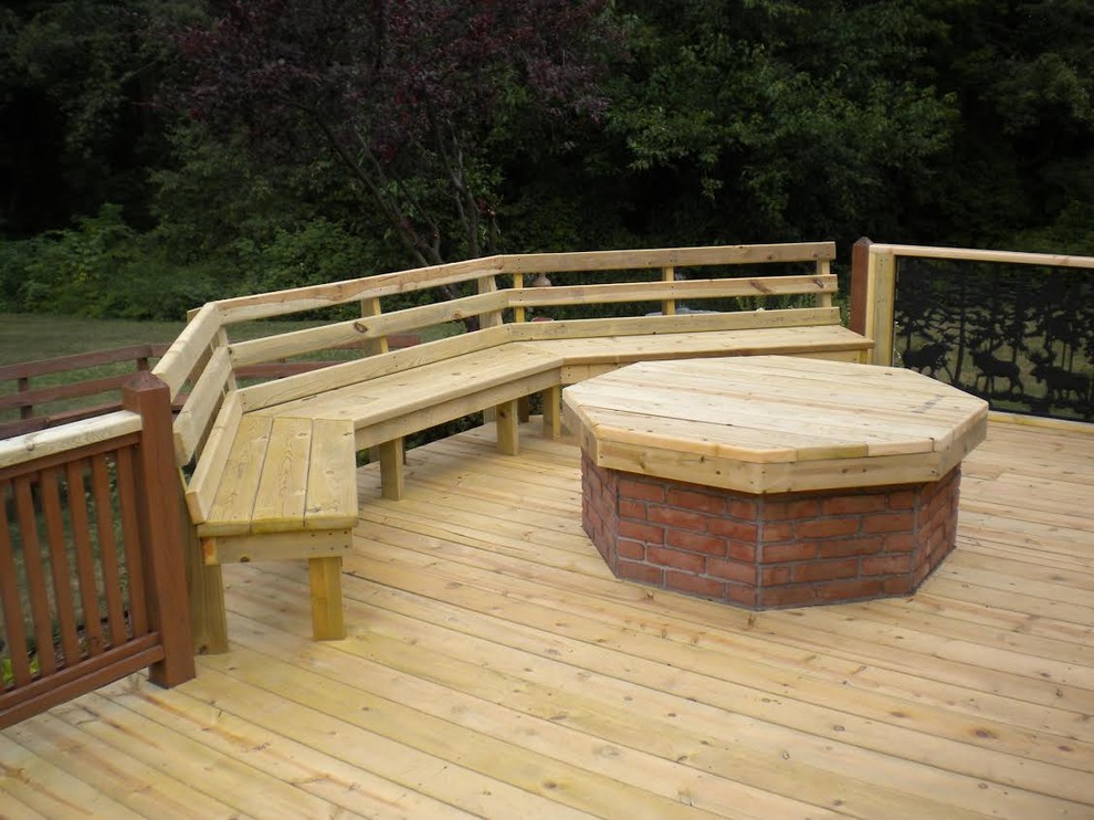 Example of a mid-sized arts and crafts backyard deck design with no cover