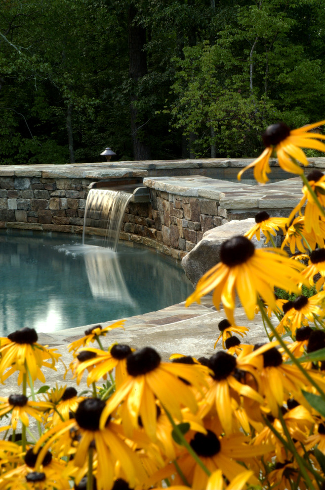 Hot tub - mid-sized rustic backyard stone and kidney-shaped hot tub idea in Atlanta