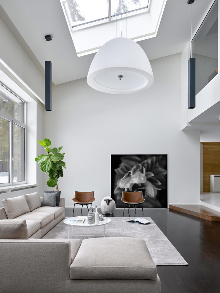 Photo of a contemporary open concept living room in Moscow with white walls, dark hardwood floors and brown floor.