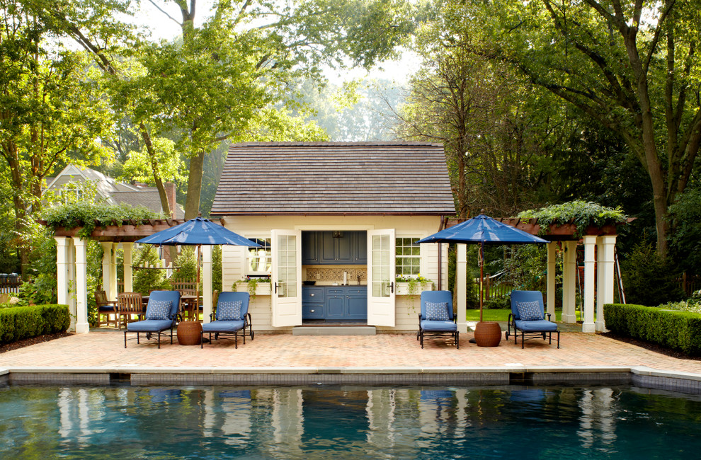 Country pool in New York with brick pavers and a pool house.