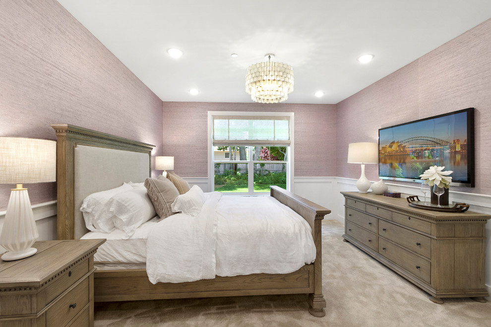 Design ideas for a mid-sized transitional bedroom in New York with pink walls, carpet, no fireplace and beige floor.