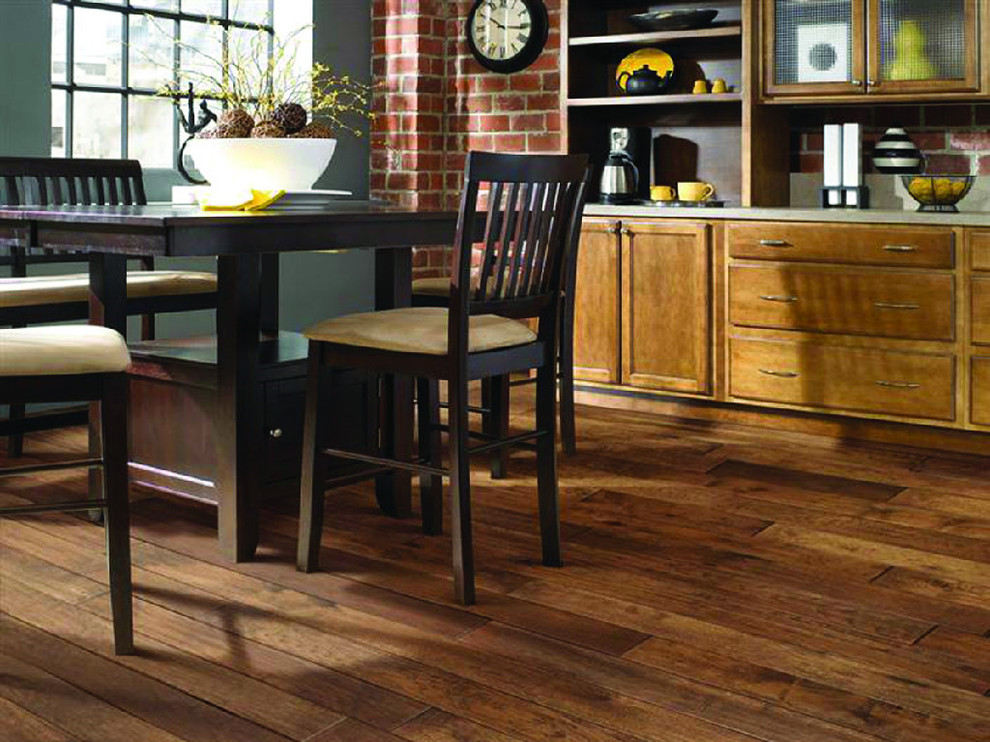 Eat-in kitchen - mid-sized traditional u-shaped ceramic tile and gray floor eat-in kitchen idea in Milwaukee with a farmhouse sink, raised-panel cabinets, medium tone wood cabinets, granite countertops, beige backsplash, stone slab backsplash, stainless steel appliances and no island